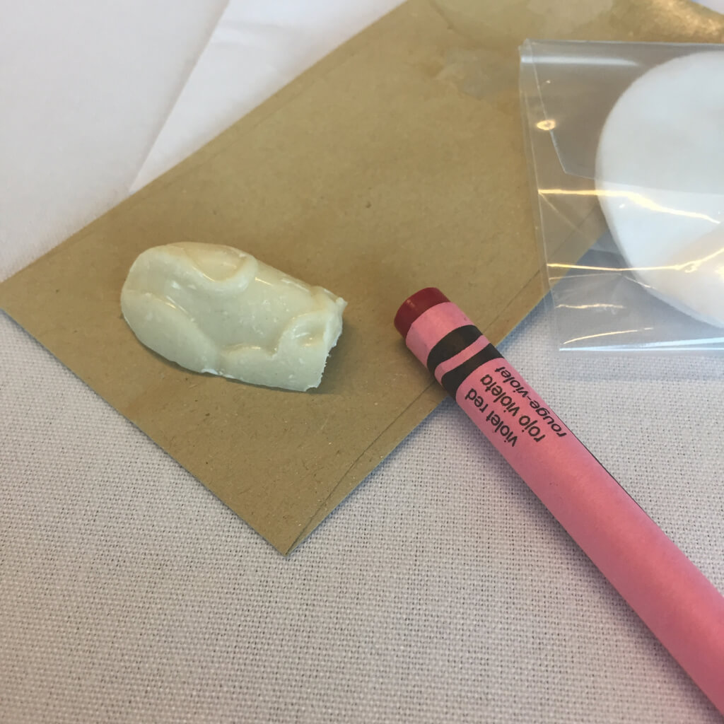 Image shows a Crayola wax crayon and a white chocolate mouse used in a creative copywriting exercises at The Copywriting Conference 2017