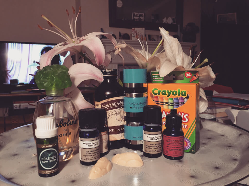 Image shows a tray filled with bottles of different scents and aromatherapy oils