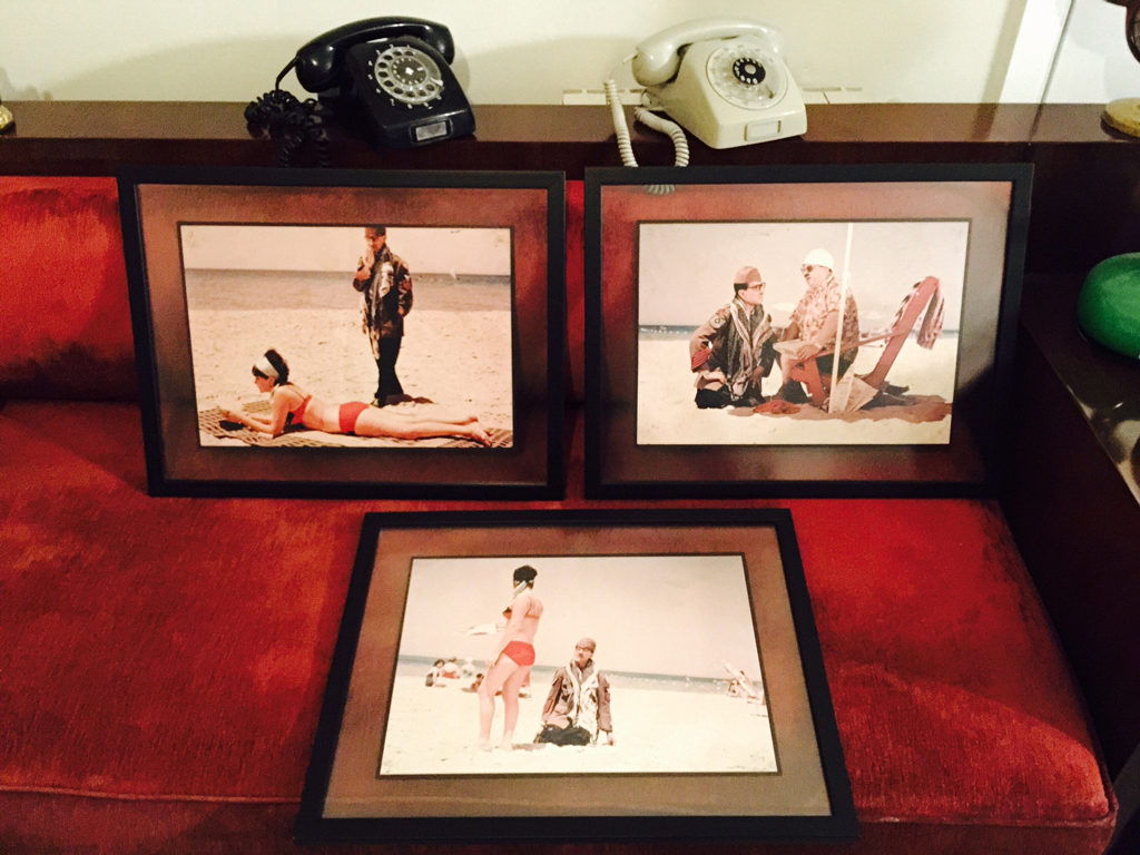 Two rotary dial telephones and a several vintage cinema lobby cards. 