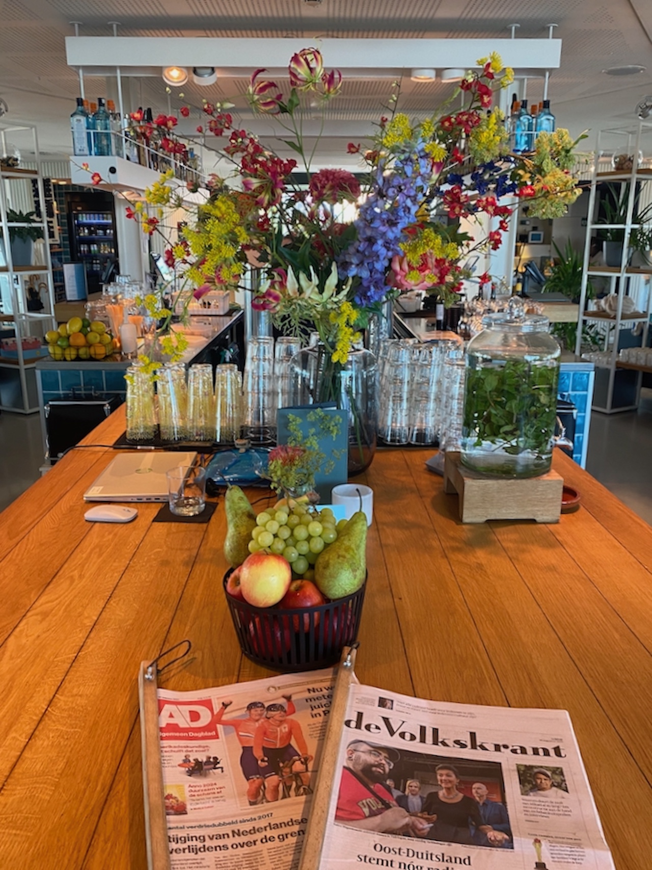 A glorious floral display and the daily newspapers in Dutch at Zoku, Amsterdam.