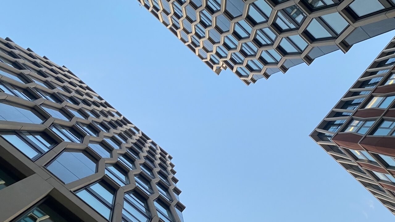 An abstract image of buildings in the City of London taken from low on the ground to represent highly-regulated industries for Haydn Grey